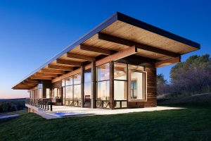 Exterior, horizontal, 3/4 view at twilight from southwest, Brandhorst residence, Alta, Wyoming; Ward + Blake Architects